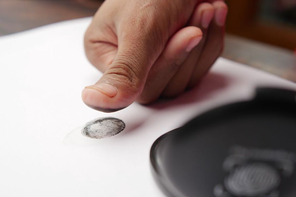 person using fingerprint scan for authentication