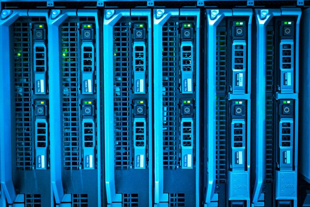 rows of servers in a data center illuminated by blue lights