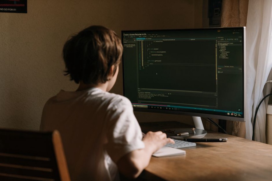 A focused learner studying C++ programming on a desktop