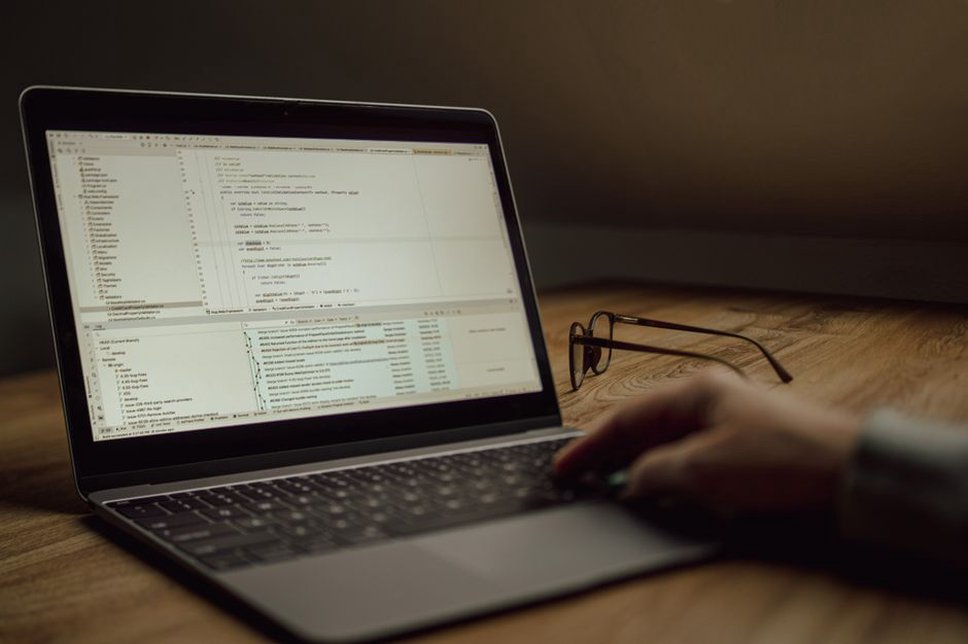 A programmer debugging a Java application on a laptop