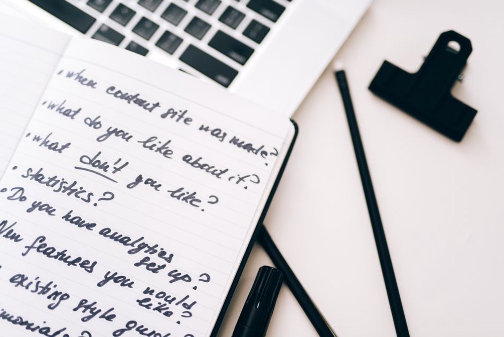 Withdrawal questions written beside a laptop